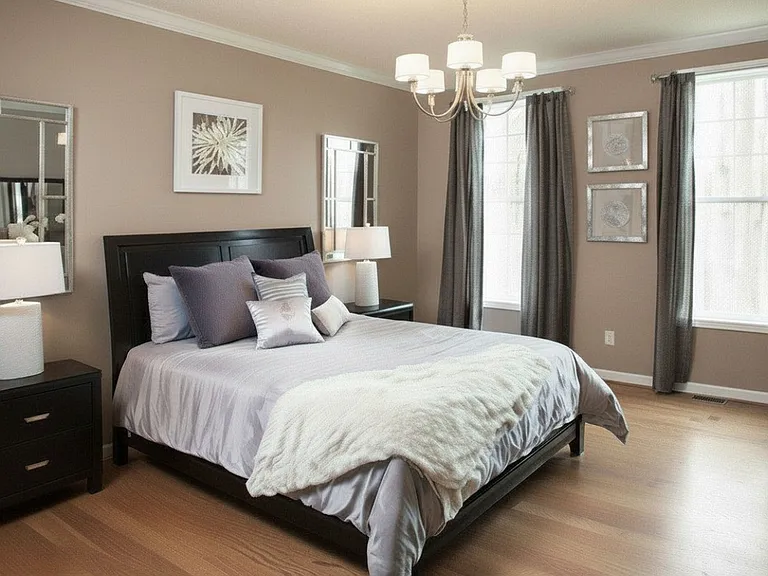 Remodeled master bedroom with hardwood floor and connecting full bathroom