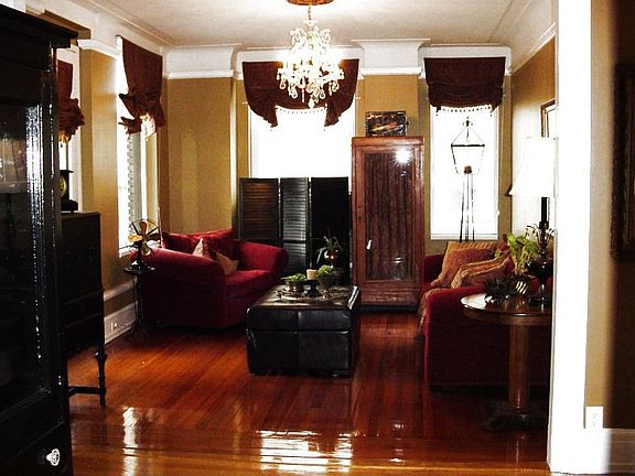 Large living room with lots of windows.