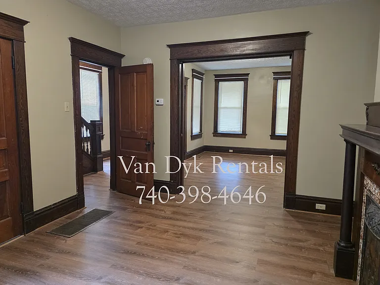 Dining room, decorative fireplace. View into Living room and foyer.