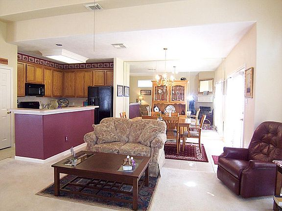 Living room flows to tiled dining area with mirrored wall, giving an open & bright feel.