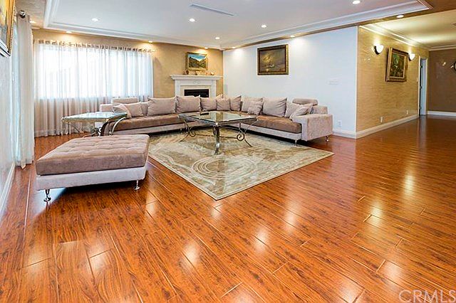 Spacious living room with fireplace, recessed lighting, Venician Plaster Walls,