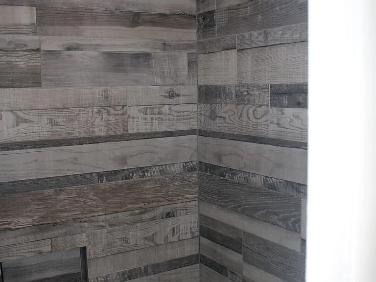 Fully remodeled second bathroom tub and shower with wall-to-wall imported tile and bronze fixtures.