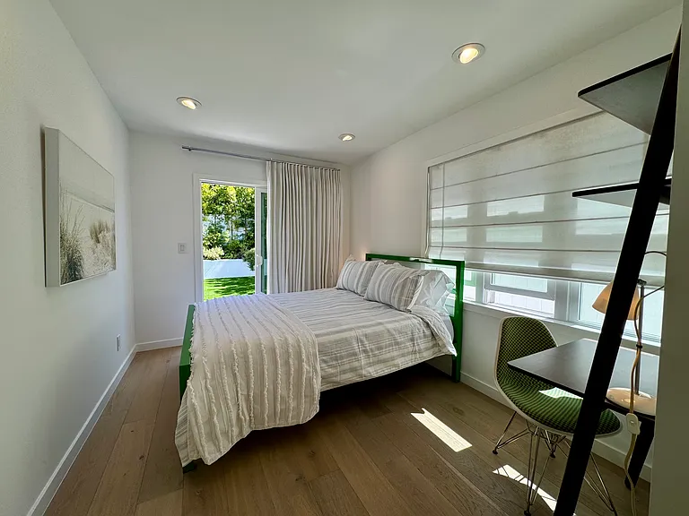 Second bedroom has access to the backyard and a small mounted tv not featured in image. Room & Board bed frame and new Casper Queen Mattress.
