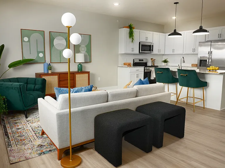 Spacious living room with hardwood flooring along side the kitchen