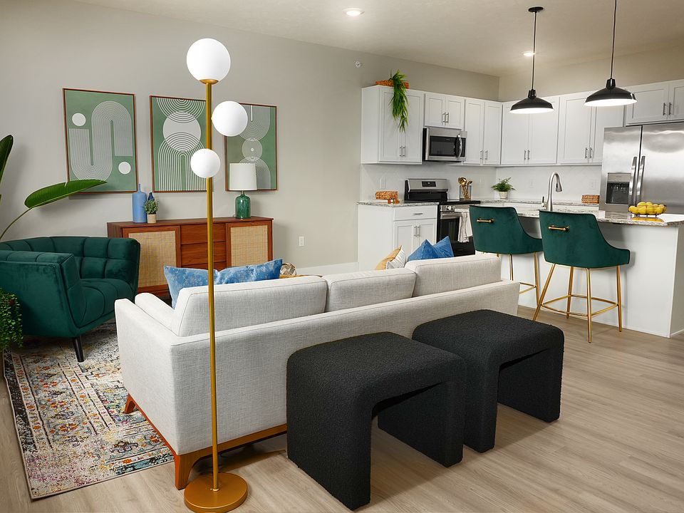 Spacious living room with hardwood flooring along side the kitchen