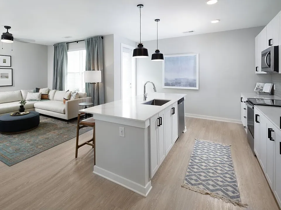 Kitchen, living, and dining areas with hard-surface vinyl plank flooring