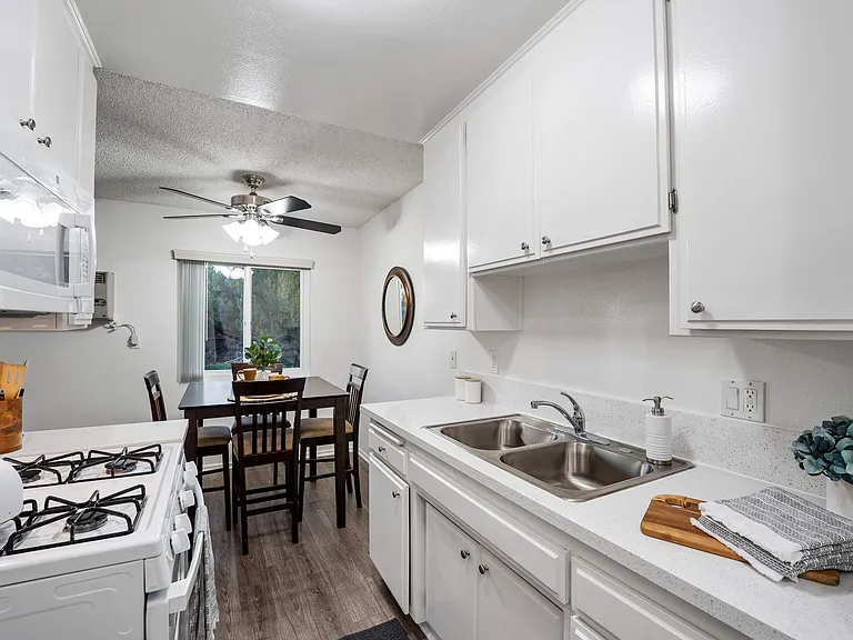 Prepare a delicious meal in your cozy Junior 1 Bedroom apartment kitchen, equipped with white cabinetry and modern appliances to inspire your inner chef.