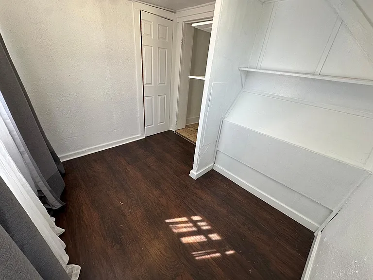 Bedroom, east and north facing windows, black out curtains and sheer curtains provided, light filled room. 
North and east facing windows.