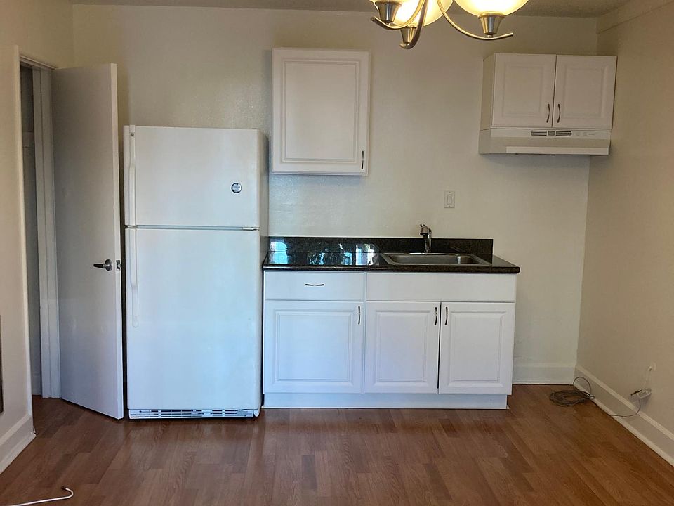 The kitchenette includes a refrigerator, sink, and stove with an oven that is being added