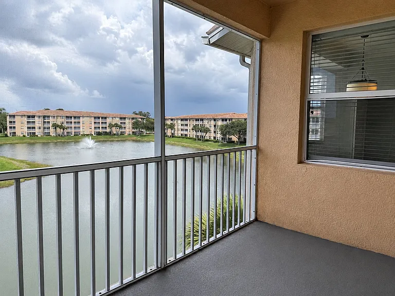 Private screened lanai with tranquil lake and fountain views