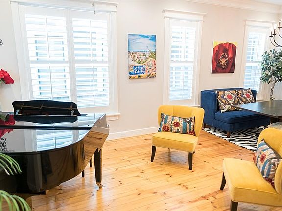 Step into the open floor plan with 10' ceiling throughout, pine hardwood floors and plantation shutters.