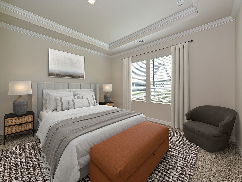 The primary bedroom is the perfect place to cozy up and read your favorite book.