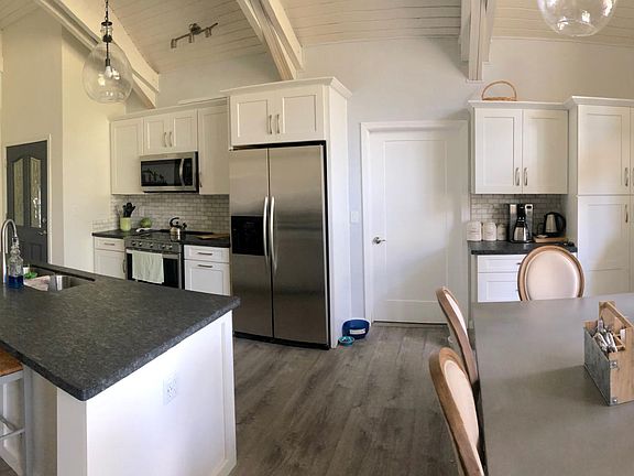 Kitchen/dining area with plenty of pantry storage, electric glass top range and leathered granite counters.