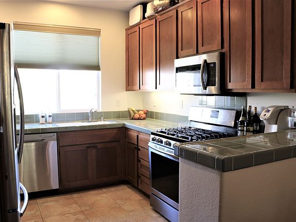 Kitchen features stainless steel appliances, lots of counter space and room above cabinets for decor or storage.