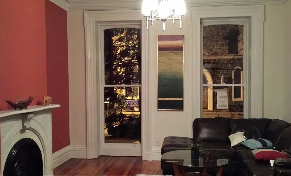 Living room with marble mantle and huge windows