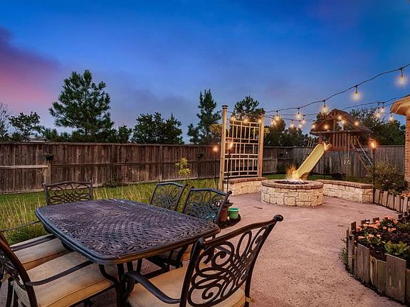 No expense was spared in this backyard - extended custom patio with brick and stone firepit and benches - beautiful landscaping - tons of privacy - and great neighbors!