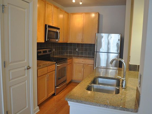 Granite counters, tile backsplash, and pantry closet