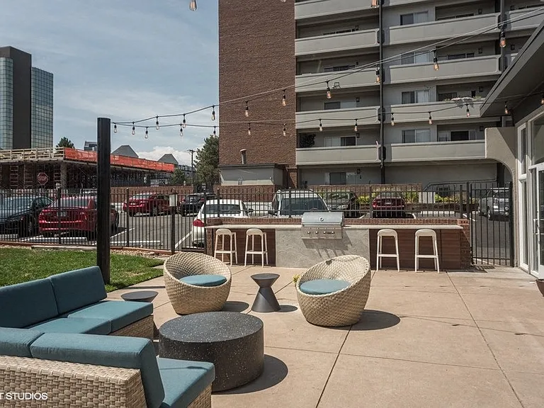 Outdoor lounge area with string lights and modern seating