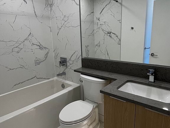 5-piece ensuite bathroom with wall-to-wall tiles and a soaker tub.