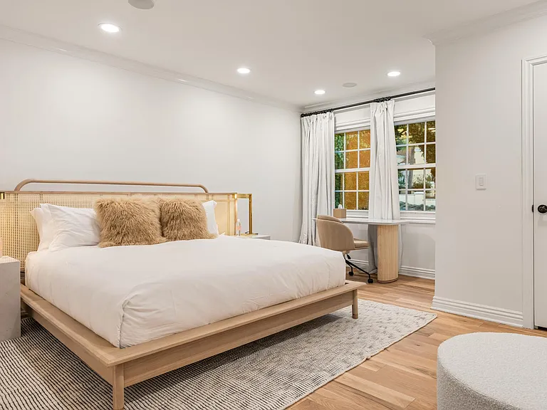 Experience a spacious retreat with a large bed and desk space, offering both comfort and functionality.