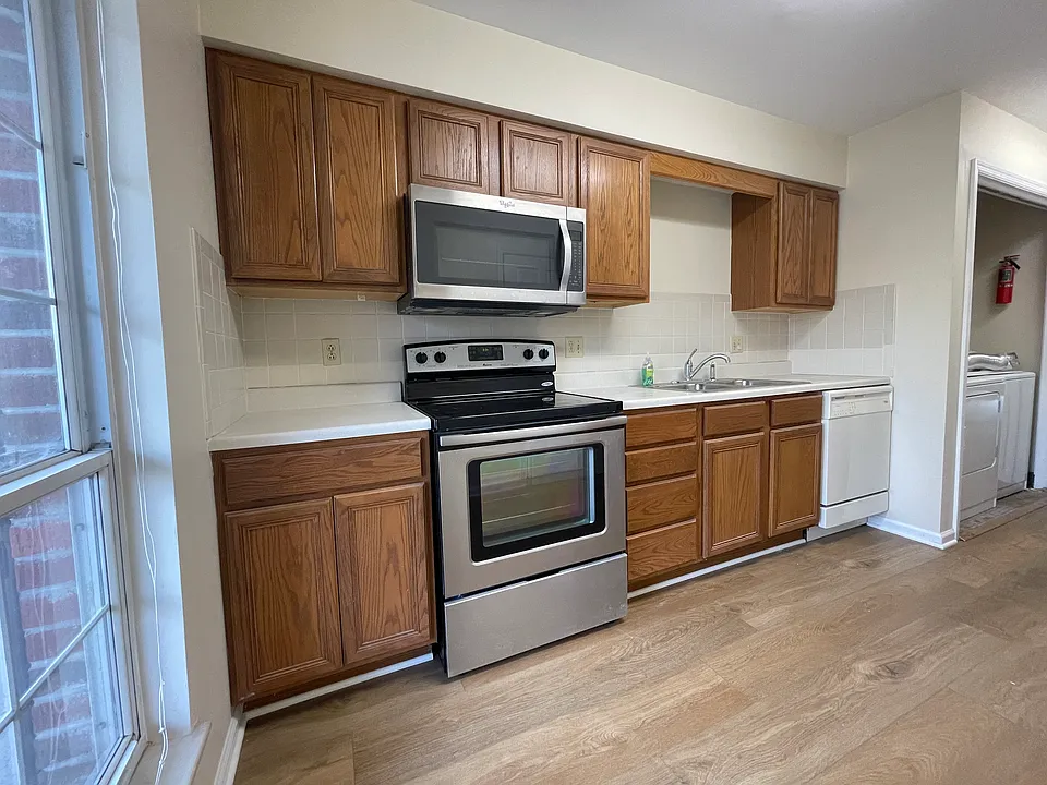Kitchen has laundry closet, nice pantry, range, microwave, dishwasher and fridge.