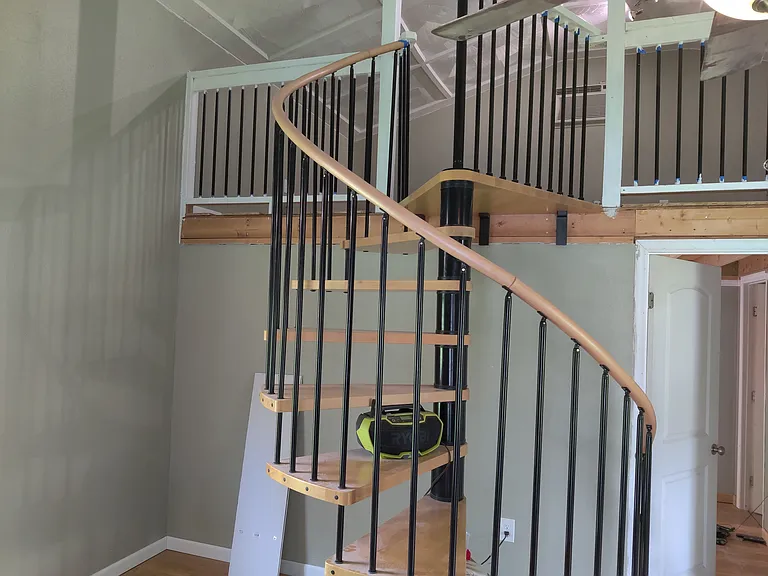 Spiral stairs in additional building and upstairs railing (additional building is 700 sq ft, it is a 20x25 metal building, the side walls are 12 feet high and the center of the building is 17 feet. It has a 10x20 upstairs office or 5th bedroom.