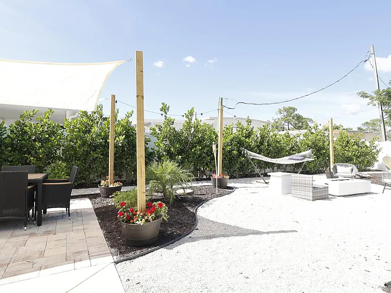 Enjoy your private, back yard with fire pit, hammock and dining area.