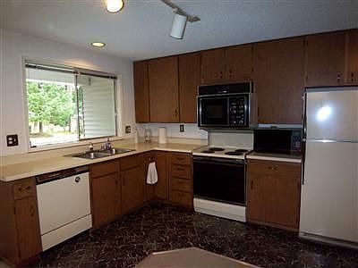 Light & bright "L" shaped kitchen comes with all the appliances. Adjacent to the kitchen is an alcov
