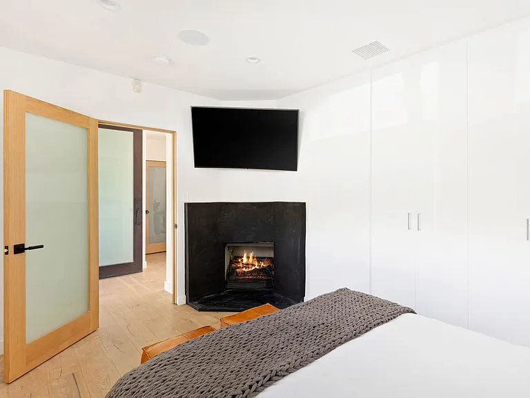 Cute bedroom with fireplace and curved LED TV