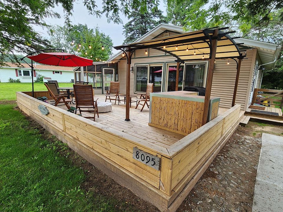 Wonderful outdoor space with kitchen/bar set up, fire pit and screened in porch.
