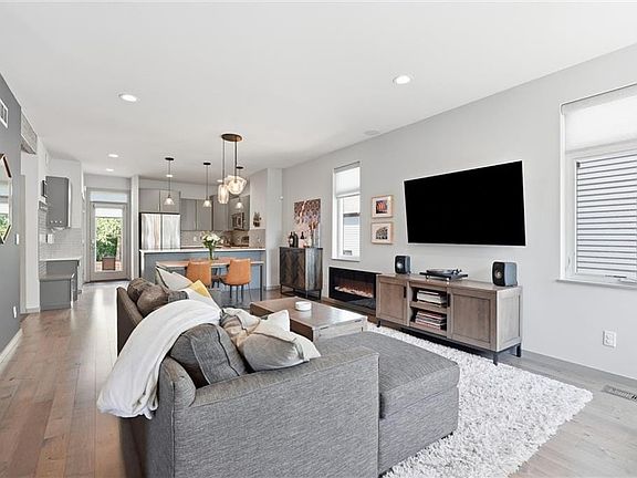 Open-concept living space featuring wood-finish flooring and recessed lighting