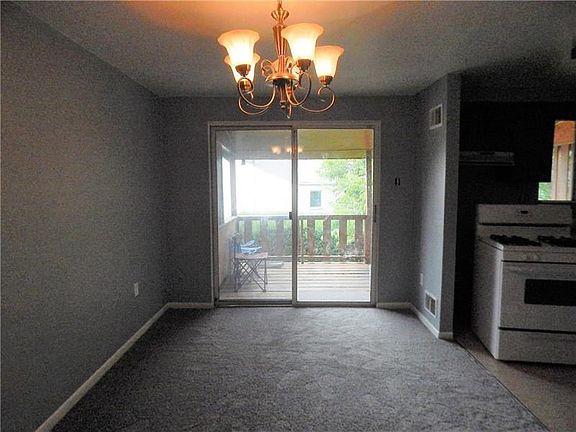 DINING ROOM WITH SLIDING DOORS TO THE COVERED DECK.