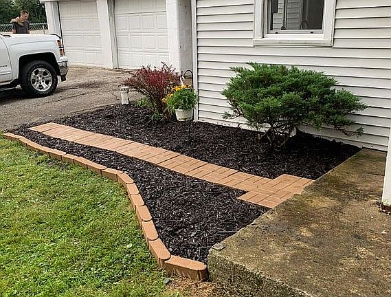 Just to the left of front porch.