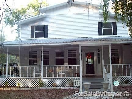 The full front view of the house with wrap around porch.