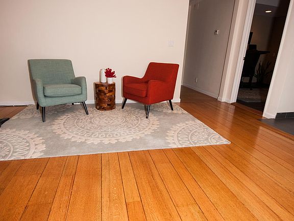 Front living room. To the Right is the kitchen. The small hallway leads to 2BA and 1 BA. The door on the right leads to multi-purpose room