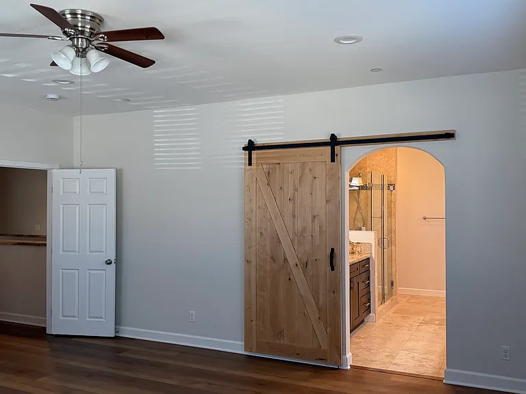 Primary bedroom with bathtub, shower and his-and-hers sinks