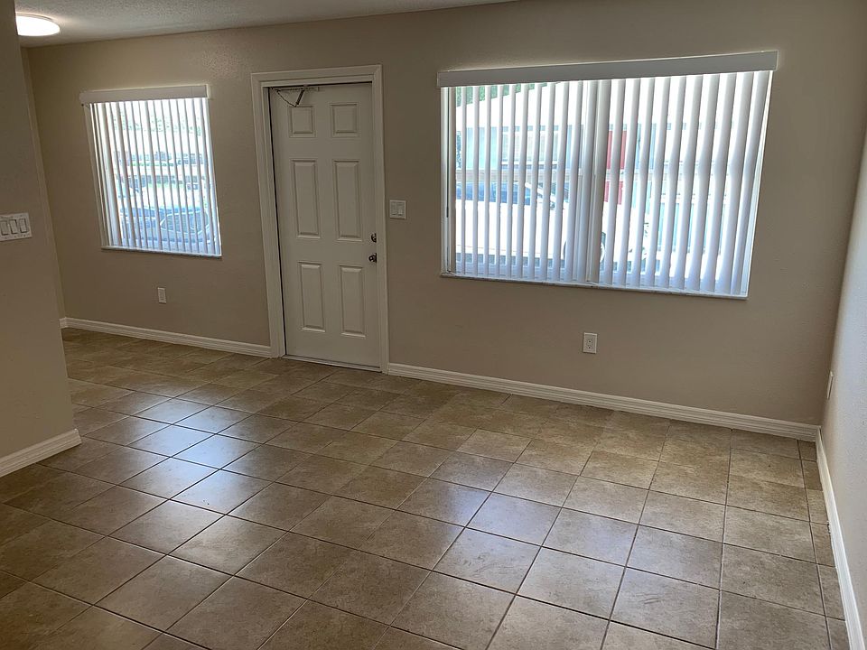 Large front windows let in natural light to the freshly painted living room.