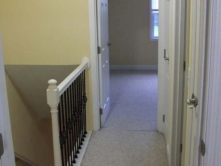 Hall between bedrooms and full bath