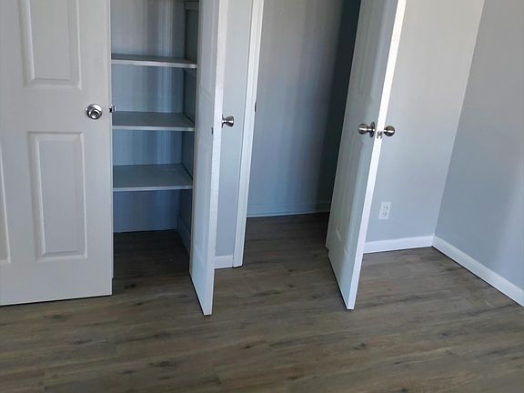 Bedroom closet with built in shelving.