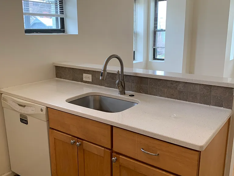 Dishwasher and large counter space. Opens to living room.