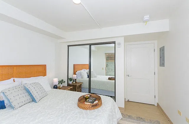 Kanekapolei Collection Bedroom with mirror doored closets and decor