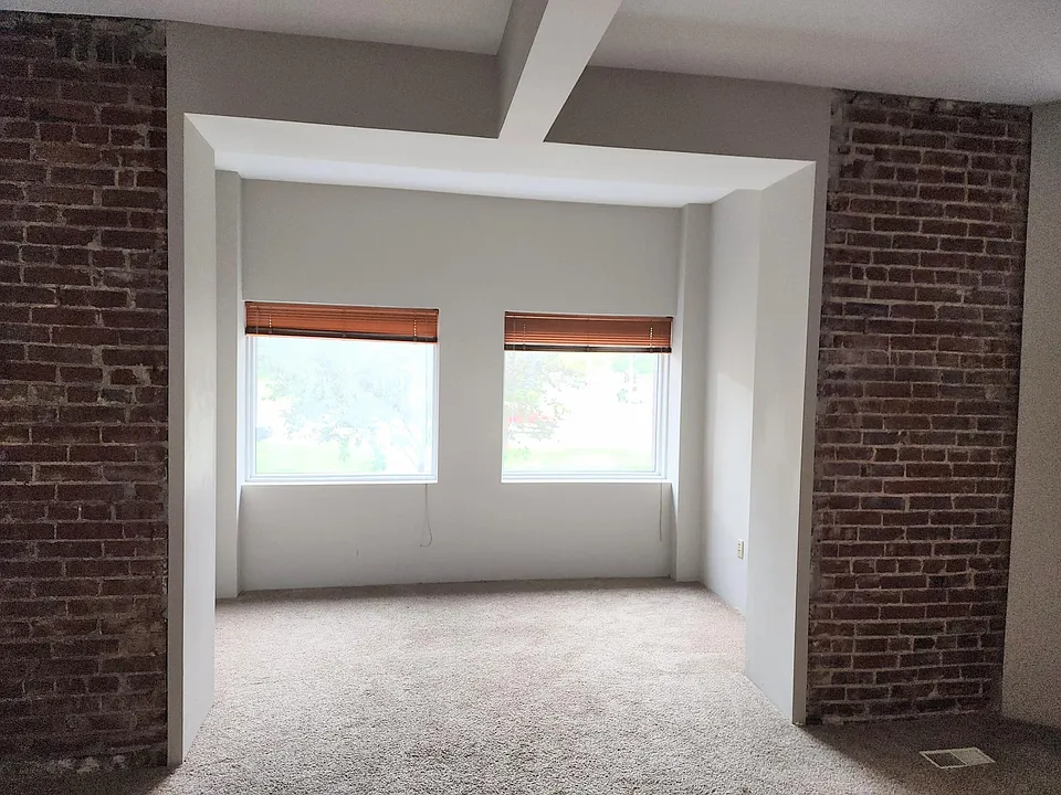 Additional living space adjoins to main living room. The windows give lots of natural light and a view of Reservois Park across the street.