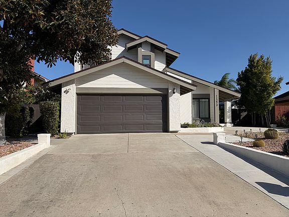 Wide driveway towards two cars garage.