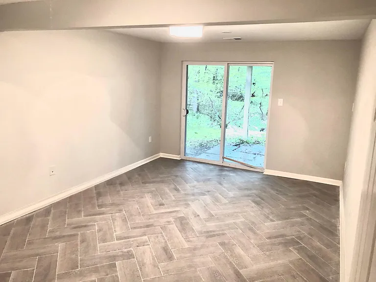 Walk-out basement bedroom w/ herringbone floors