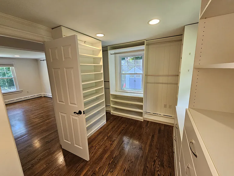 Spacious walk-in closet conveniently located within the primary bedroom suite, offering practical storage and organization.