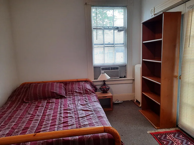 bedroom with bookshelf on the other side