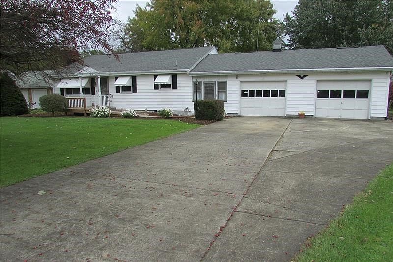 Exterior front of this well built ranch, breezeway, screened in back porch and 2 car garage.