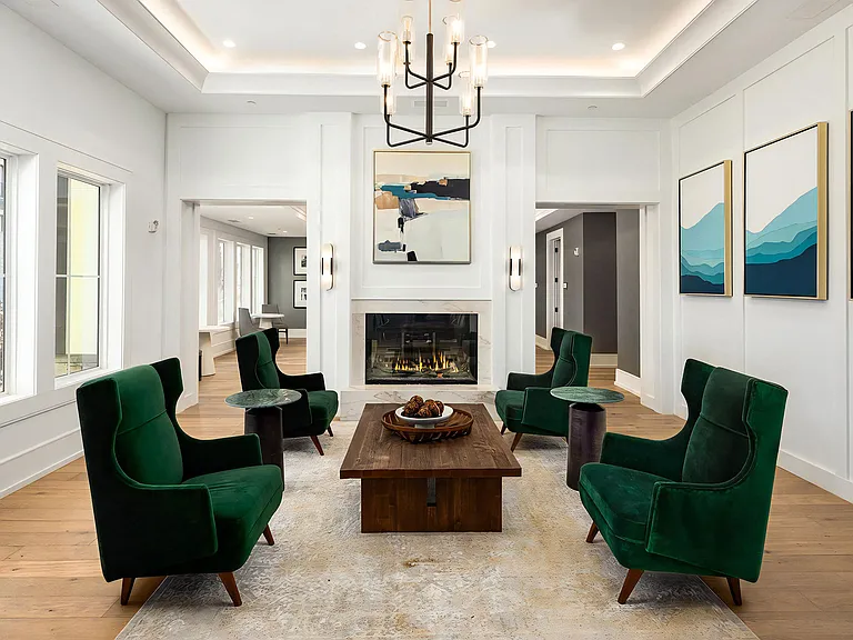 Stylish Lounge with Fireplace, Chandelier, and Velvet Accent Chairs