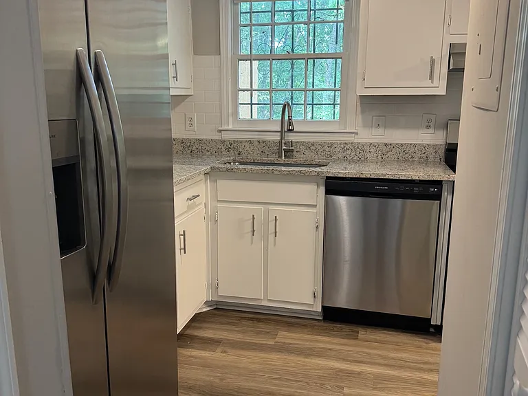 Kitchen with New Granite Counters and Stainless Steel Appliances