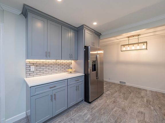 Coffee bar with under cabinet lighting.
The kitchen has a lot of surface space and cabinetry.